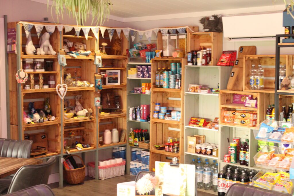 Shelves of groceries, local produce and gifts inside the shop at The Command Post