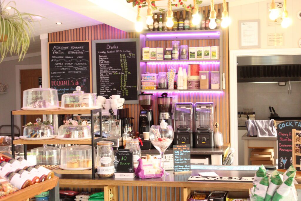 The drinks counter at The Command Post, with the chalkboard menu, cake stands and coffee machines